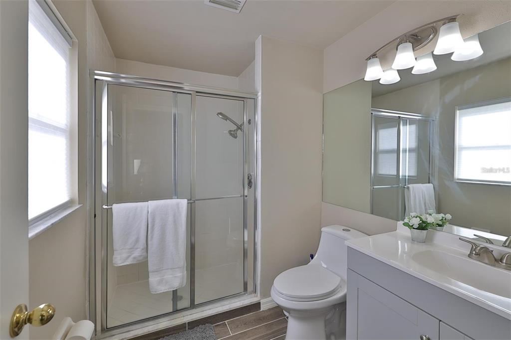 128 Lookout Drive Apollo Beach, FL 33572 - Photo 20 of 36 a bathroom with a granite countertop sink toilet and shower