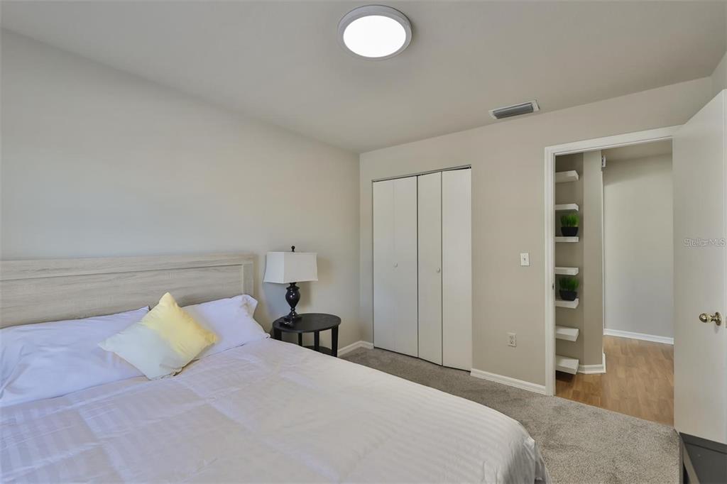 128 Lookout Drive Apollo Beach, FL 33572 - Photo 24 of 36 a bedroom with a bed and lamp