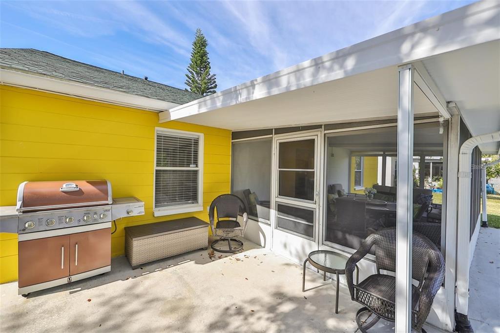 128 Lookout Drive Apollo Beach, FL 33572 - Photo 31 of 36 a bedroom with furniture and a chandelier