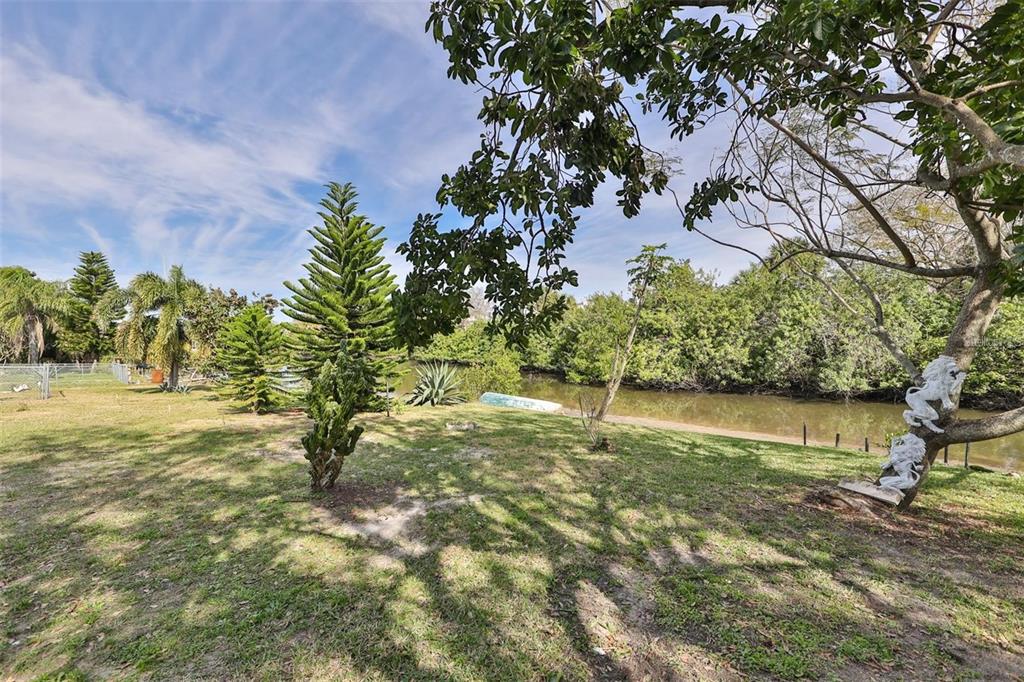 128 Lookout Drive Apollo Beach, FL 33572 - Photo 32 of 36 a view of a yard with a tree
