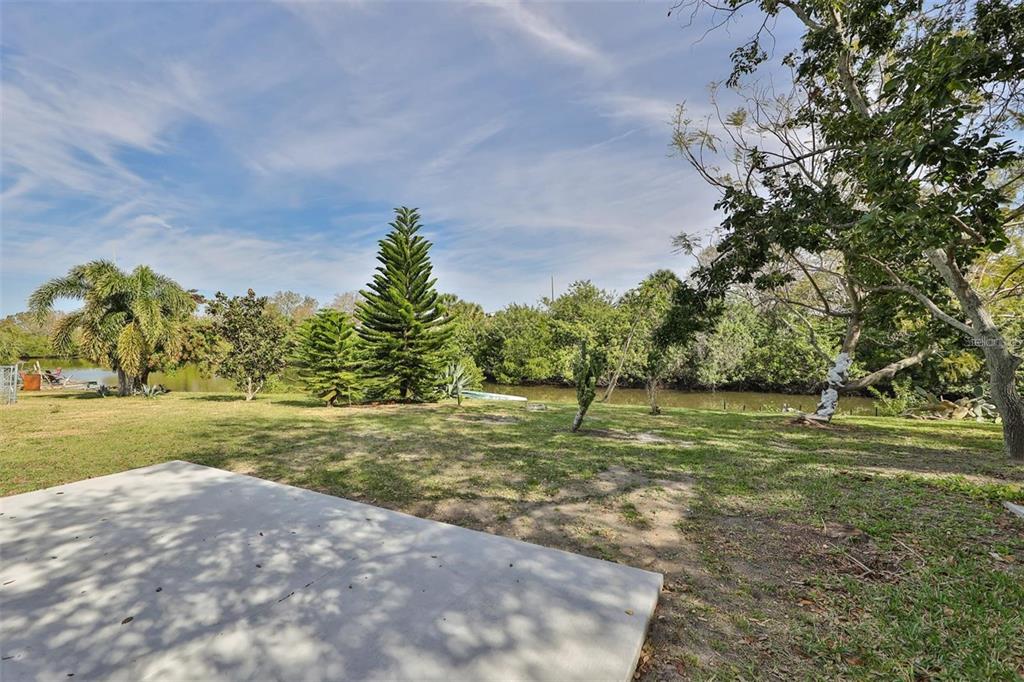 128 Lookout Drive Apollo Beach, FL 33572 - Photo 34 of 36 a view of a big yard with an outdoor space and seating
