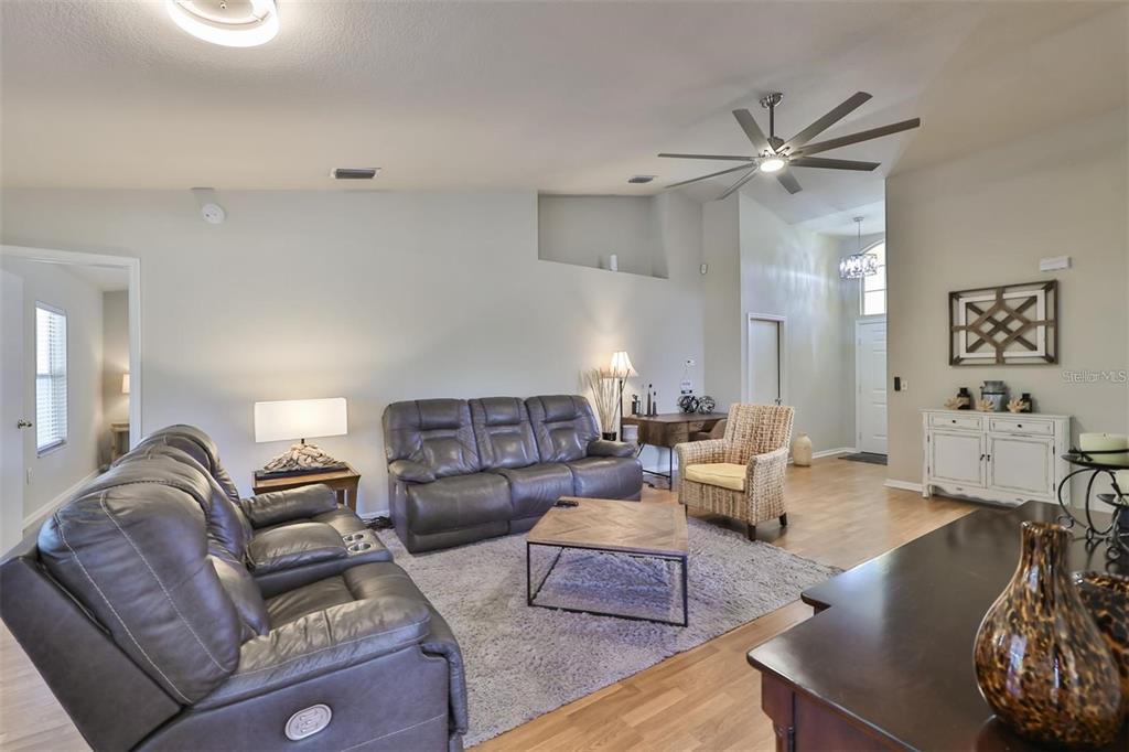 128 Lookout Drive Apollo Beach, FL 33572 - Photo 8 of 36 a living room with furniture and a view of kitchen
