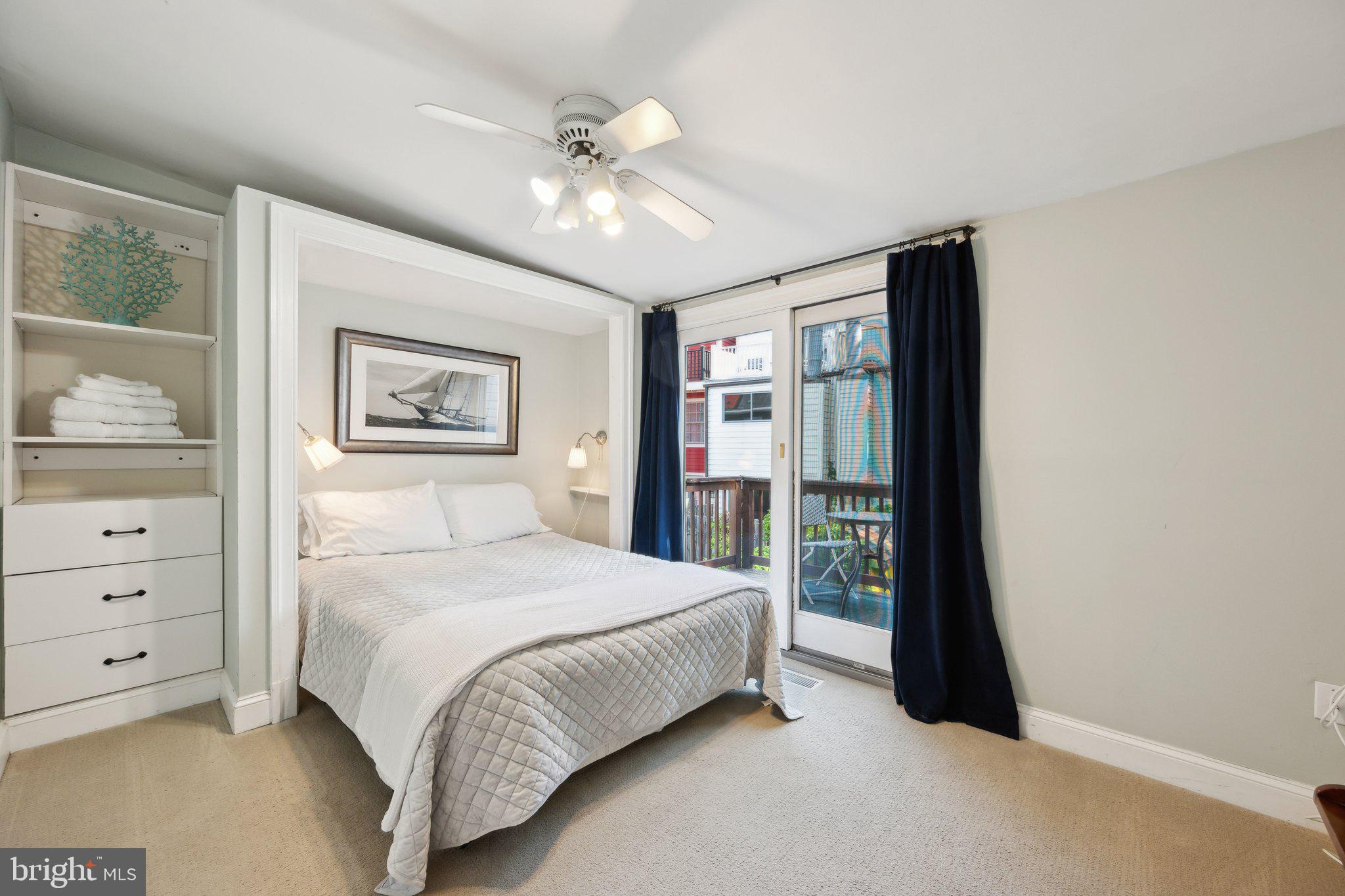 24 Fleet Street Annapolis, MD 21401 - Photo 13 of 32 a bedroom with a large bed and a chandelier