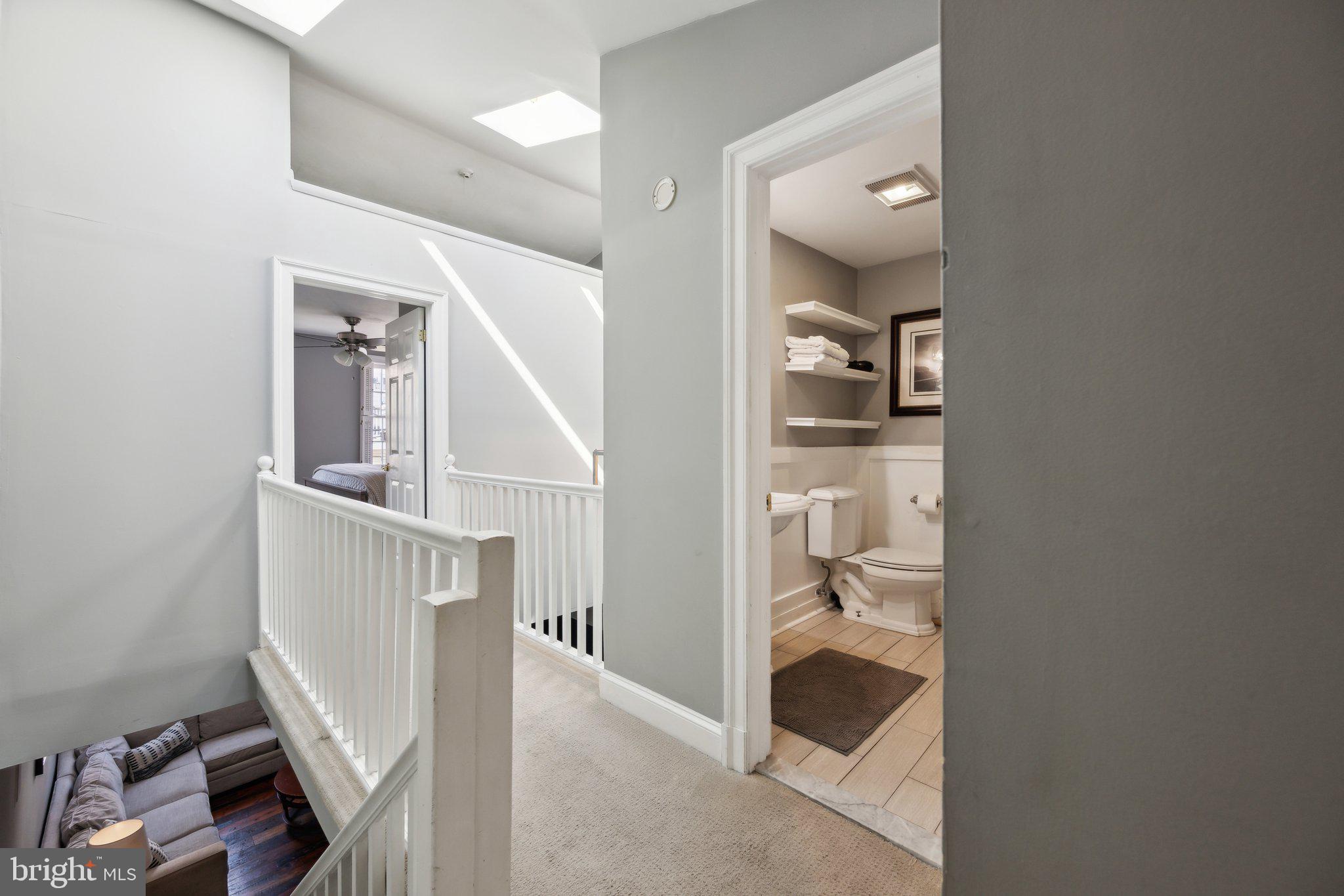 24 Fleet Street Annapolis, MD 21401 - Photo 15 of 32 a view of a hallway with white walls and cabinet