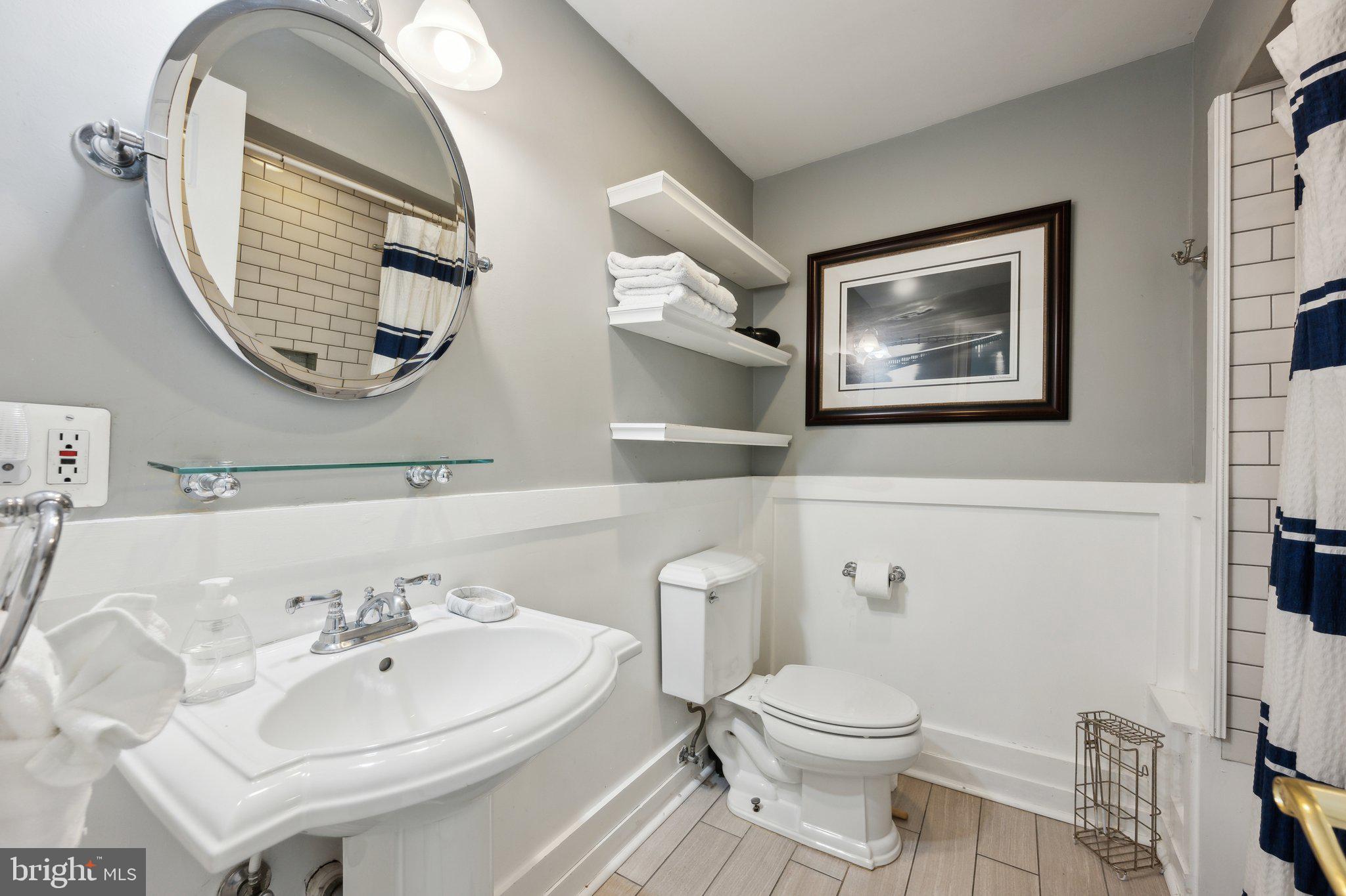 24 Fleet Street Annapolis, MD 21401 - Photo 16 of 32 a bathroom with a toilet a sink and mirror