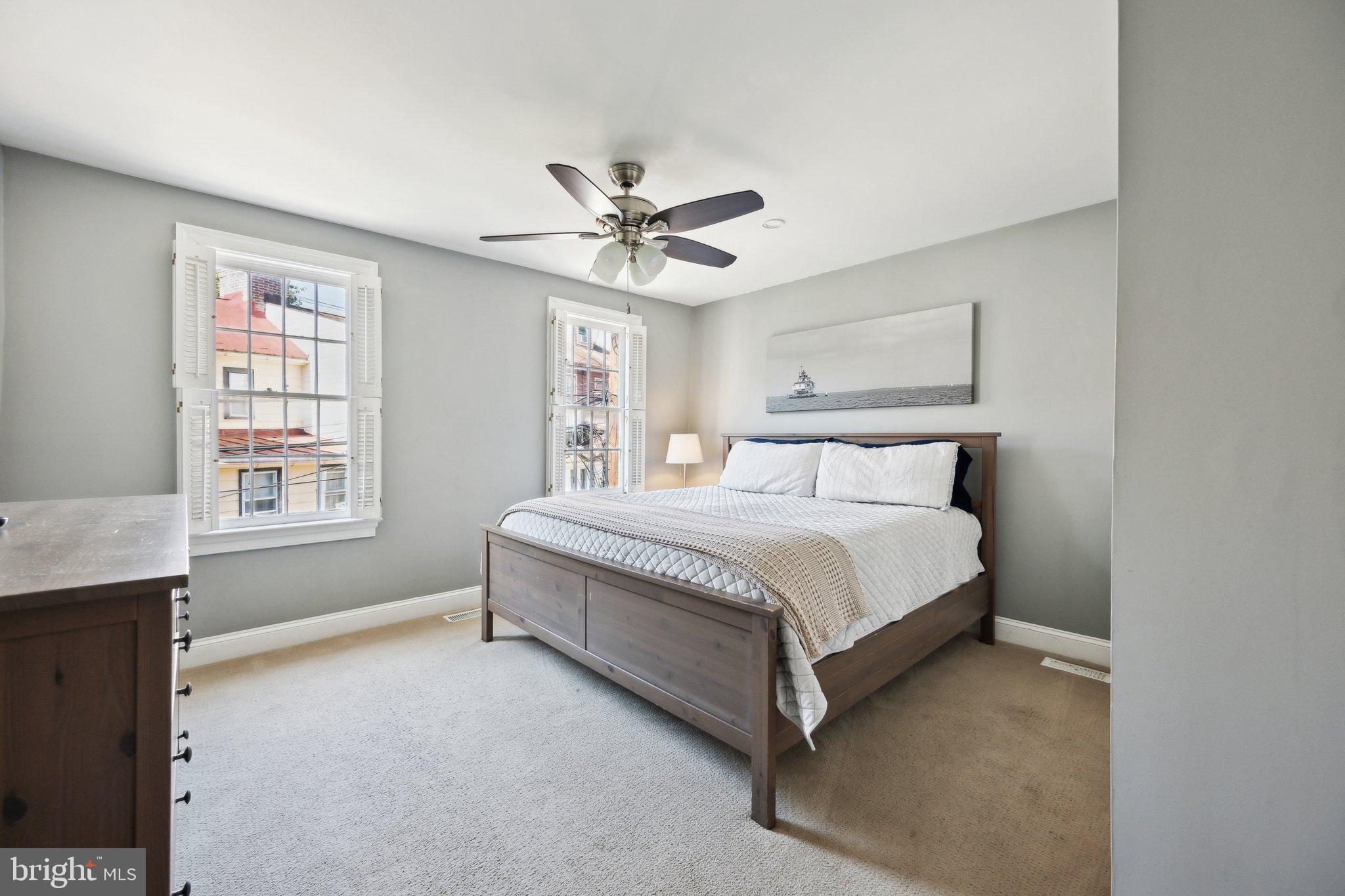24 Fleet Street Annapolis, MD 21401 - Photo 18 of 32 a spacious bedroom with a bed and a chandelier