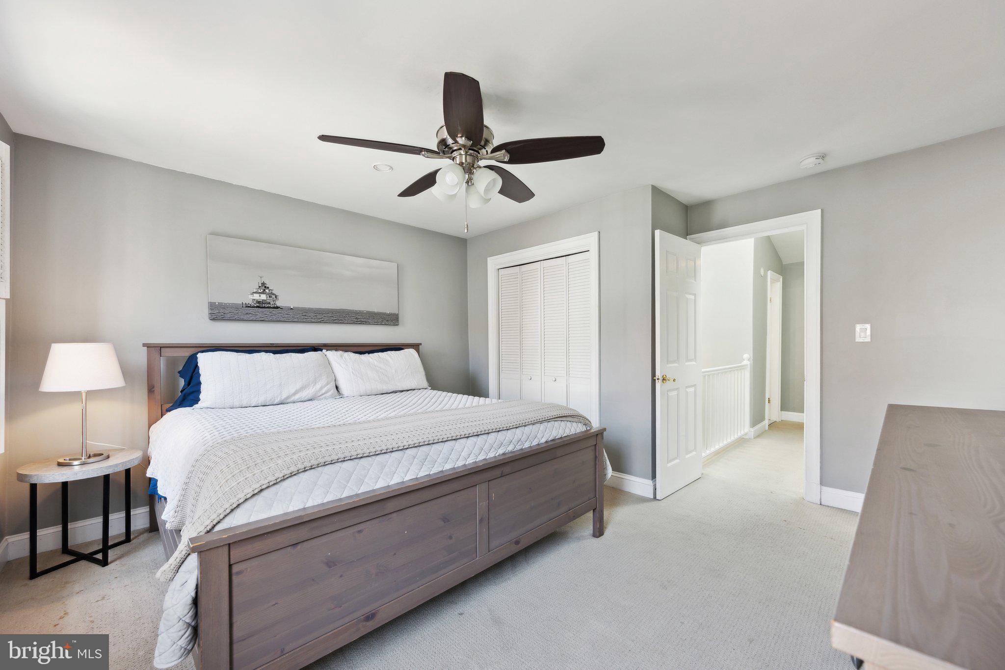 24 Fleet Street Annapolis, MD 21401 - Photo 19 of 32 a spacious bedroom with a bed and a chandelier