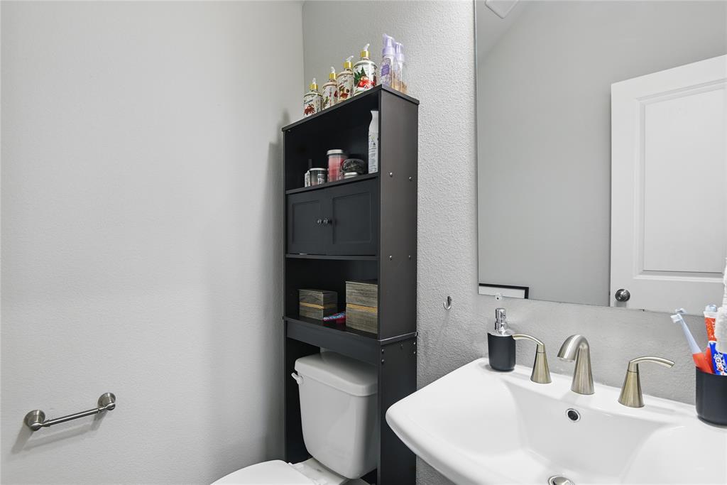 1164 Red Hawk Lane Forney, TX 75126 - Photo 18 of 27 a bathroom with a sink and a toilet