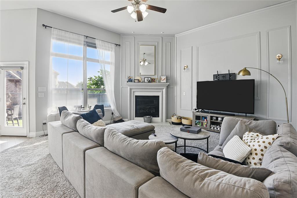 1164 Red Hawk Lane Forney, TX 75126 - Photo 8 of 27 a living room with furniture a fireplace and a flat screen tv