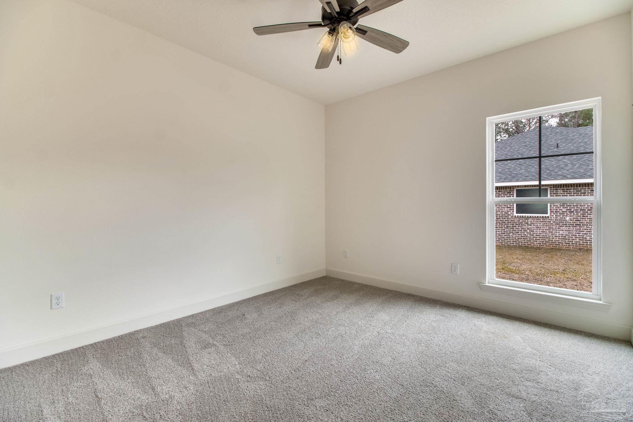 4310 Watkins Street Pace, FL 32571 - Photo 53 of 58 an empty room with a window and ceiling fan