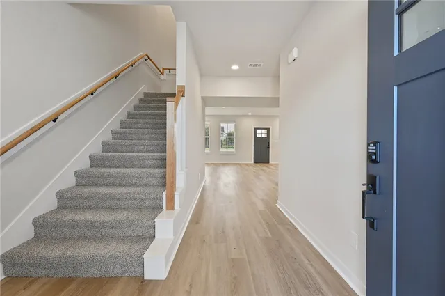 a view of entryway and hall with wooden floor