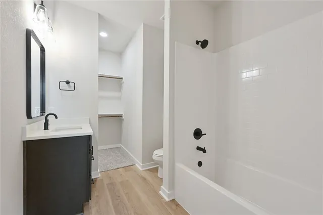 an empty room with a window and a ceiling fan