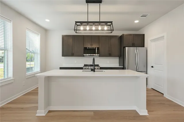 a spacious bathroom with a sink a mirror and vanity