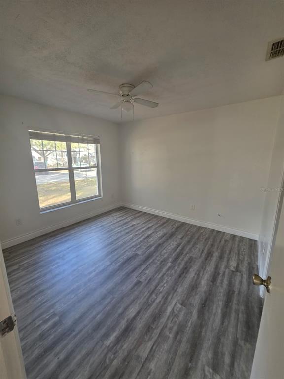 2358 Water View Loop Kissimmee, FL 34743 - Photo 11 of 26 an empty room with wooden floor and windows
