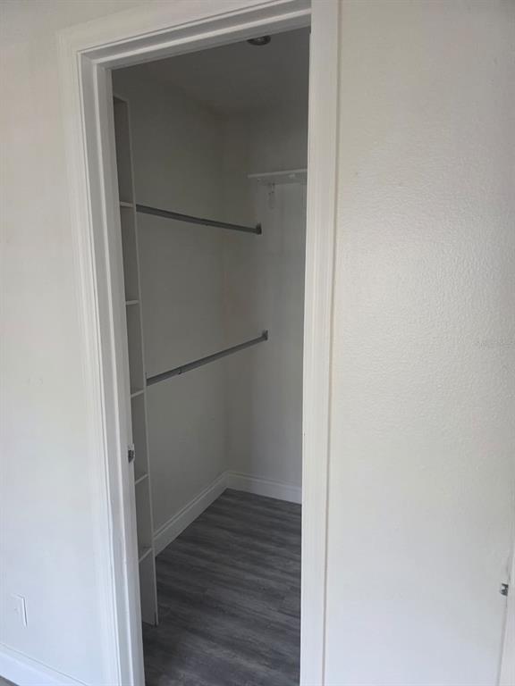 2358 Water View Loop Kissimmee, FL 34743 - Photo 13 of 26 a view of an empty walk in closet with wooden floor