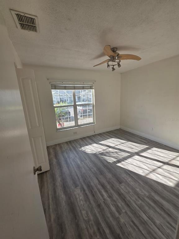 2358 Water View Loop Kissimmee, FL 34743 - Photo 14 of 26 wooden floor in an empty room with a window