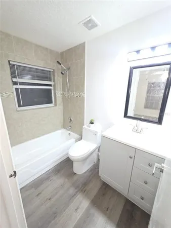 a spacious bathroom with a toilet sink and mirror