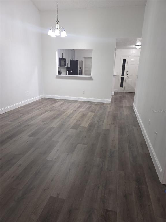 2358 Water View Loop Kissimmee, FL 34743 - Photo 20 of 26 an empty room with wooden floor and windows