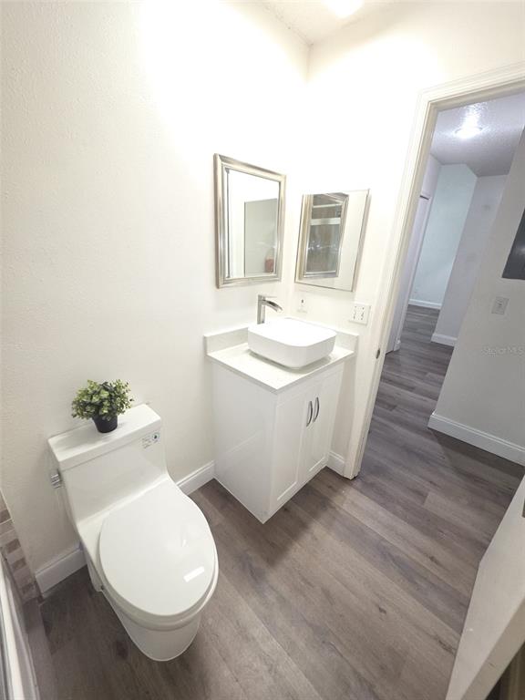 2358 Water View Loop Kissimmee, FL 34743 - Photo 25 of 26 a spacious bathroom with a toilet sink and mirror