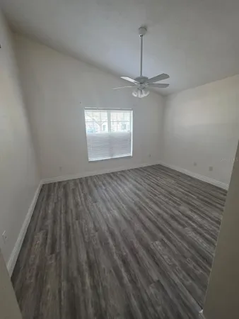 a view of an empty walk in closet with wooden floor