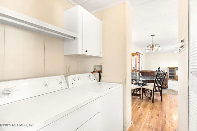 a kitchen with a dining table chairs and white appliances