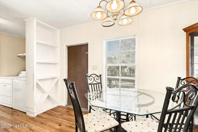 a view of a dining room with furniture and wooden floor