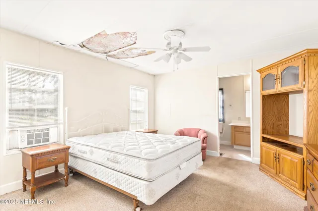 a bedroom with a bed a table and chair