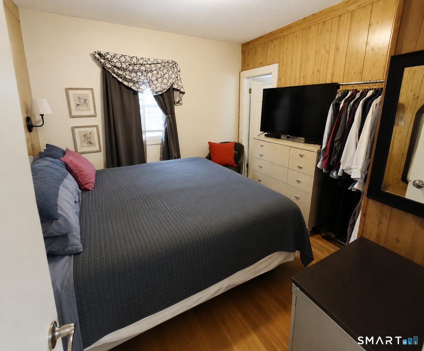 61 Bartlett Street Meriden, CT 06451 - Photo 15 of 30 a bedroom with a bed tv and a flat screen tv