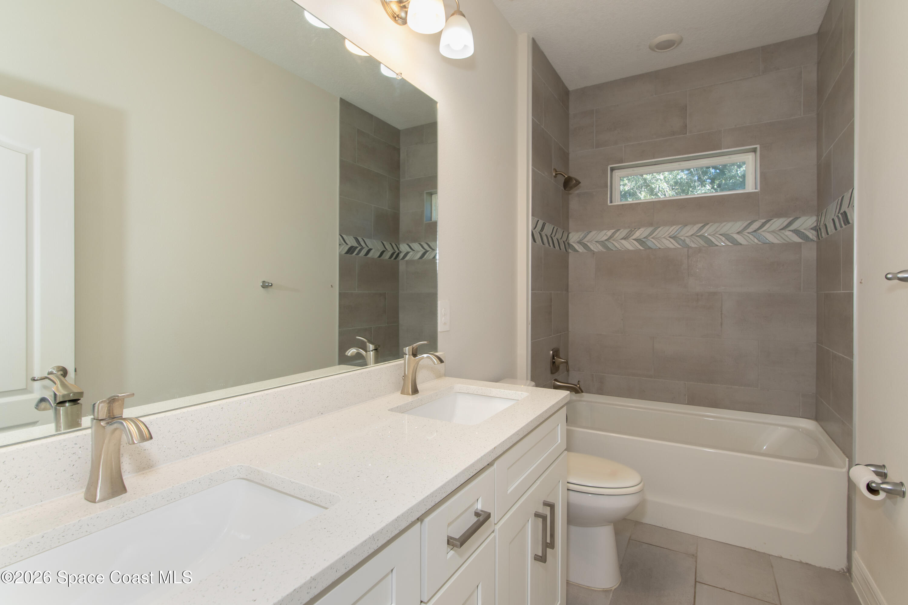 200 Triana Avenue Southwest Palm Bay, FL 32908 - Photo 13 of 27 a bathroom with a sink a toilet and shower