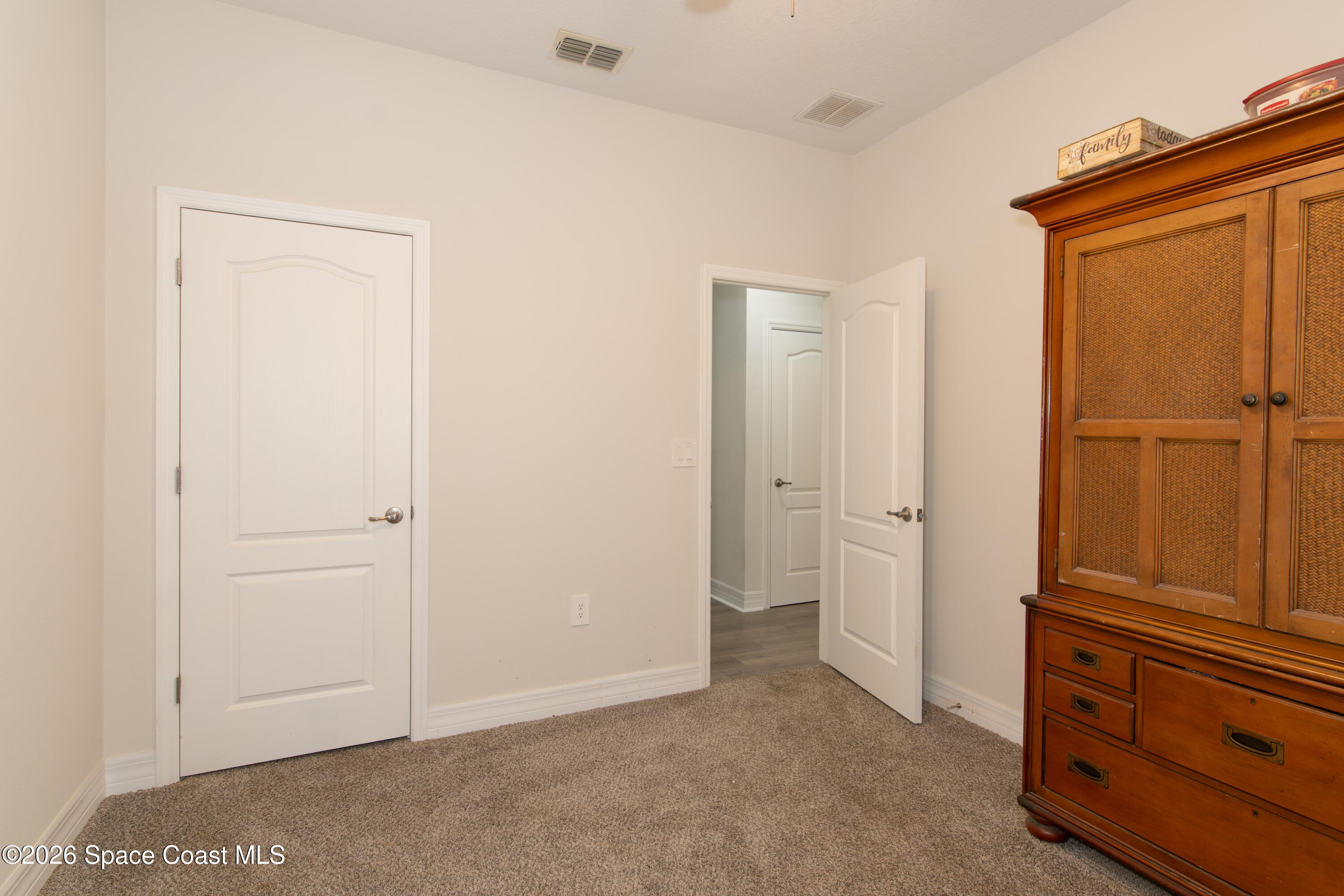 200 Triana Avenue Southwest Palm Bay, FL 32908 - Photo 15 of 27 an empty room with wooden door