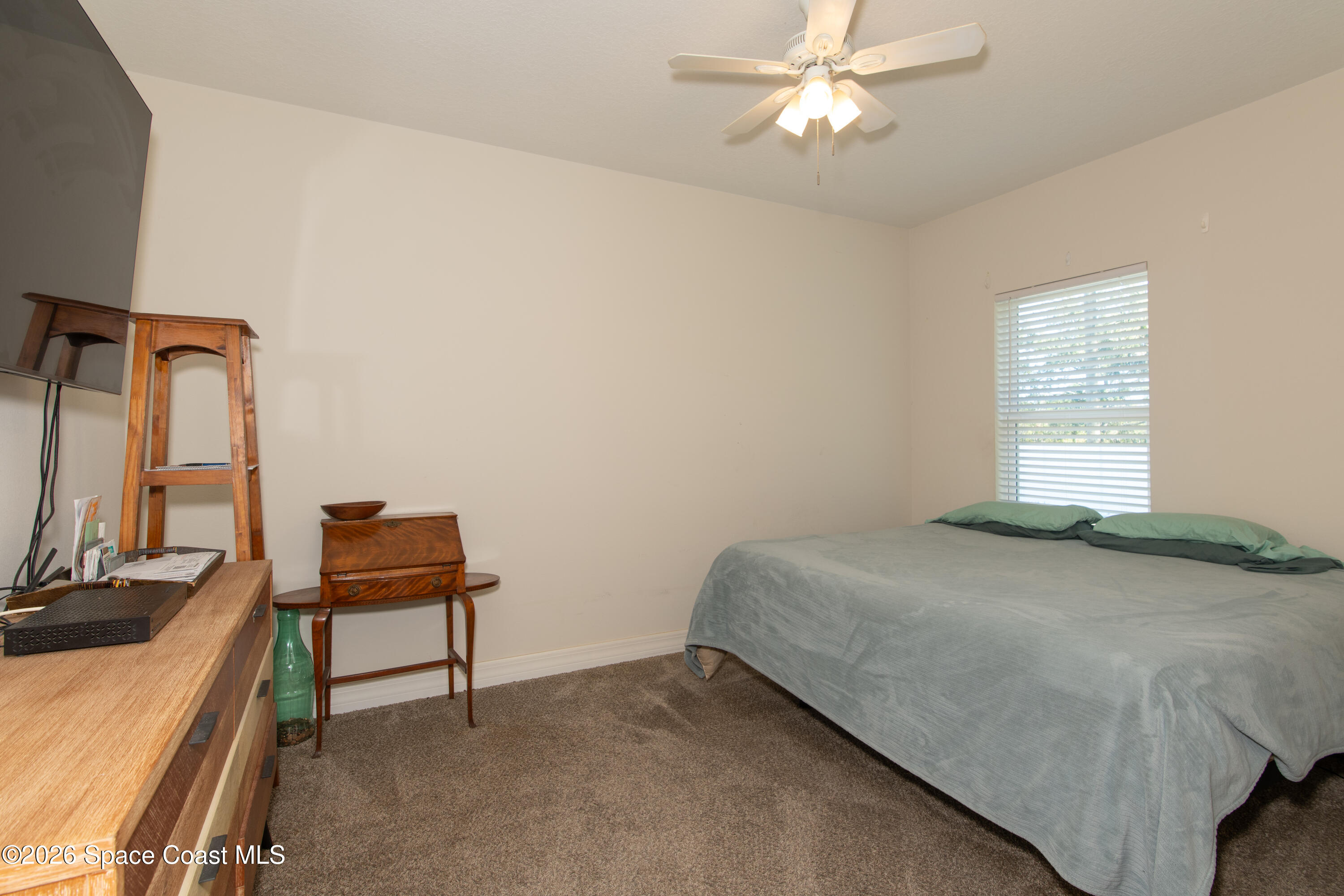 200 Triana Avenue Southwest Palm Bay, FL 32908 - Photo 16 of 27 a bedroom with a bed and a desk