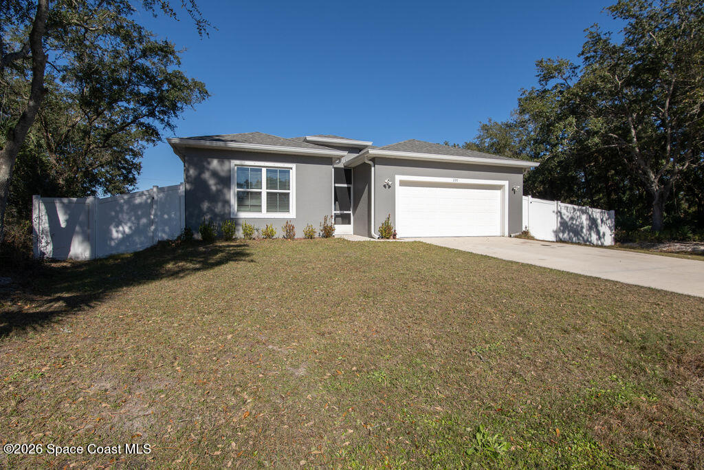 200 Triana Avenue Southwest Palm Bay, FL 32908 - Photo 2 of 27 a view of a house with a yard and garage