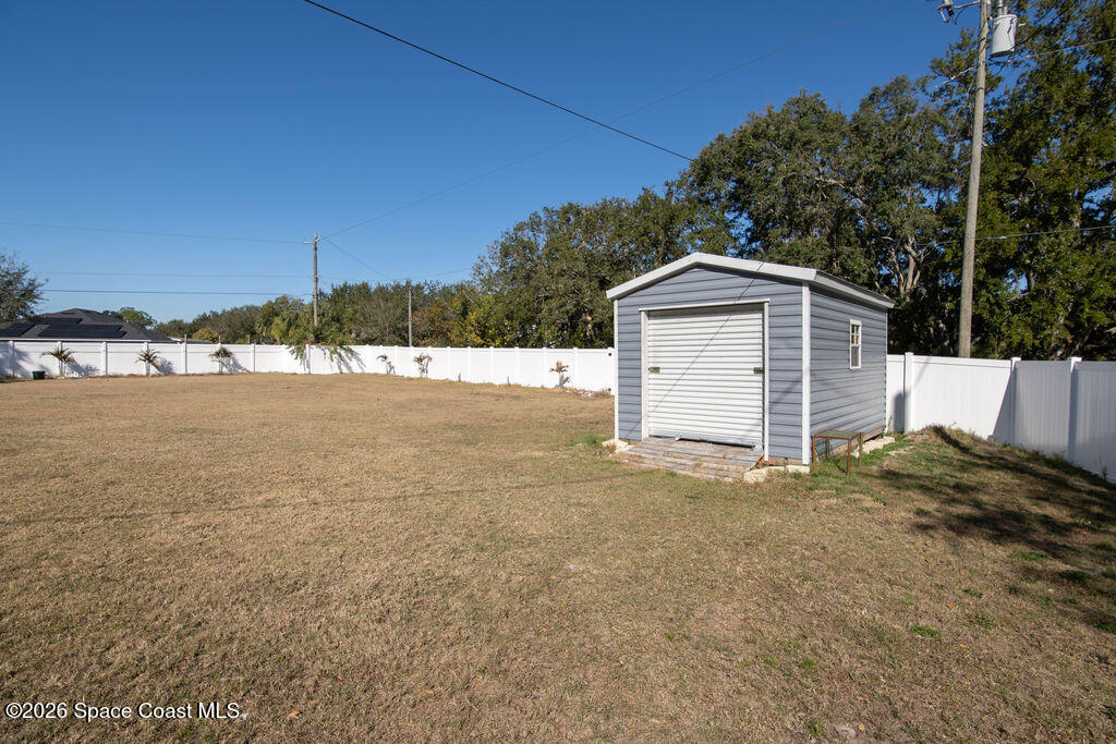 200 Triana Avenue Southwest Palm Bay, FL 32908 - Photo 22 of 27 a backyard of a house with a yard and garage