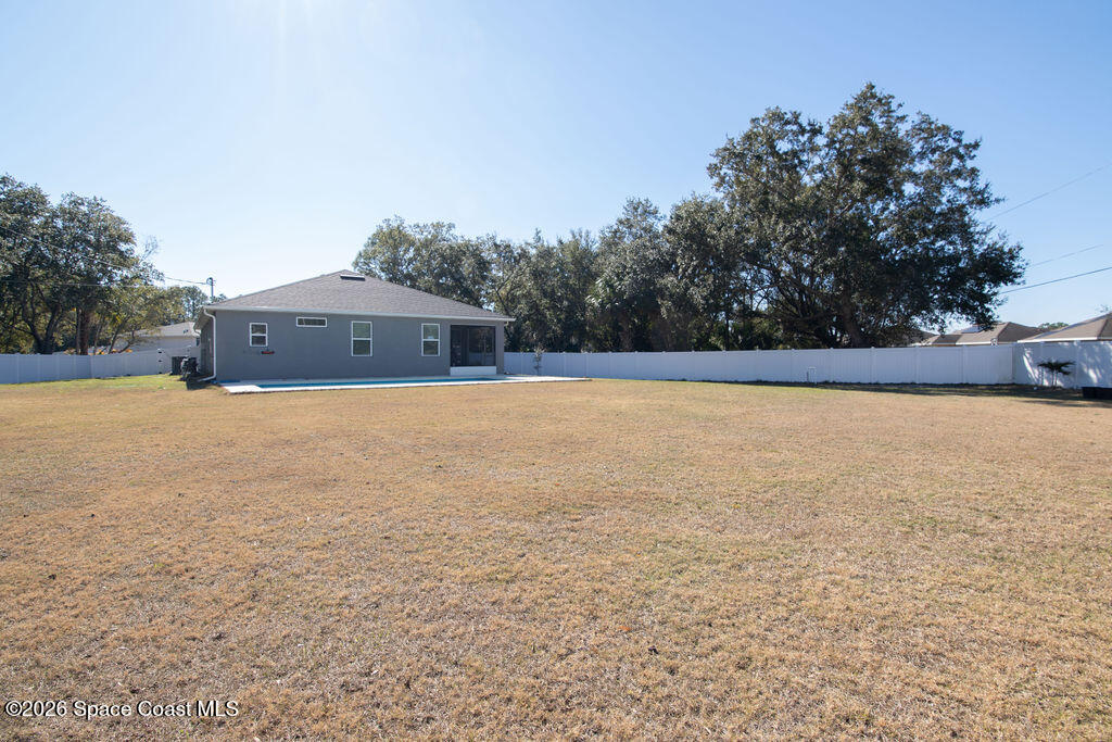 200 Triana Avenue Southwest Palm Bay, FL 32908 - Photo 23 of 27 a view of a swimming pool and trees in the background