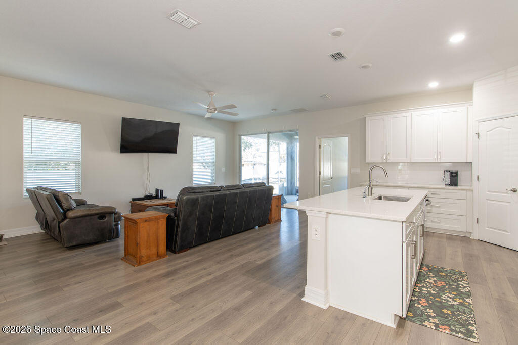 200 Triana Avenue Southwest Palm Bay, FL 32908 - Photo 4 of 27 a living room with furniture and a flat screen tv