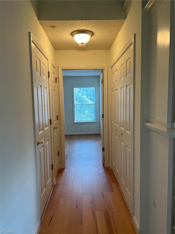 5003 Bass Chapel Road, Unit 3B Greensboro, NC 27455 - Photo 23 of 39 hallway to 2nd Bath & Bed