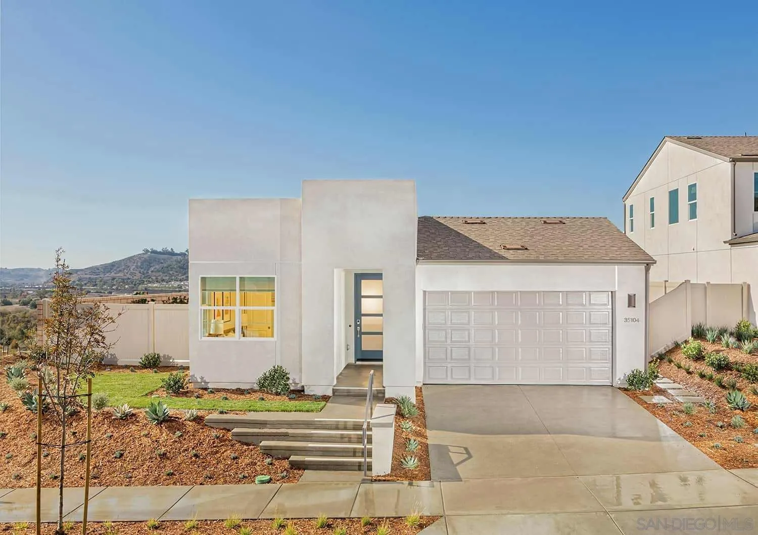 35104 Cooper Place, Unit 106 Fallbrook, CA 92028 - Photo 1 of 13 a front view of a house with a garden