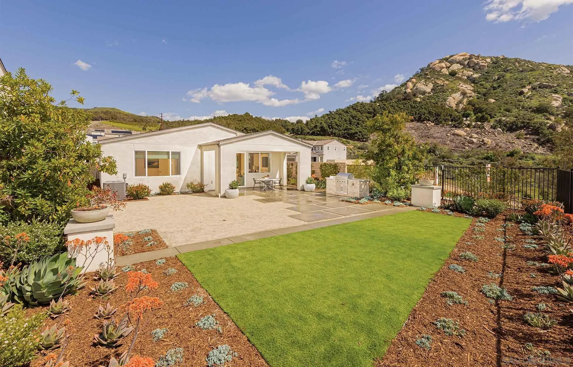 35104 Cooper Place, Unit 106 Fallbrook, CA 92028 - Photo 2 of 13 a front view of a house with a yard