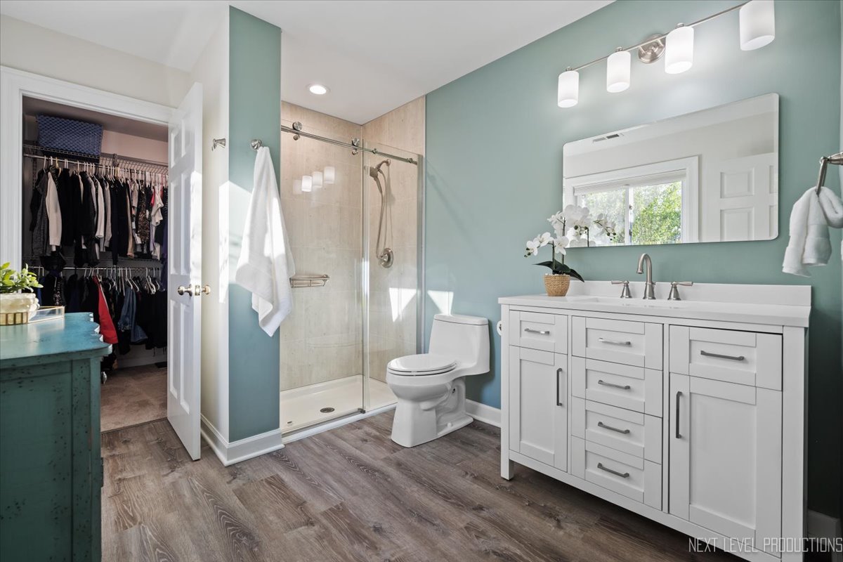 703 Wakeman Avenue Wheaton, IL 60187 - Photo 14 of 20 a bathroom with a granite countertop sink toilet and shower