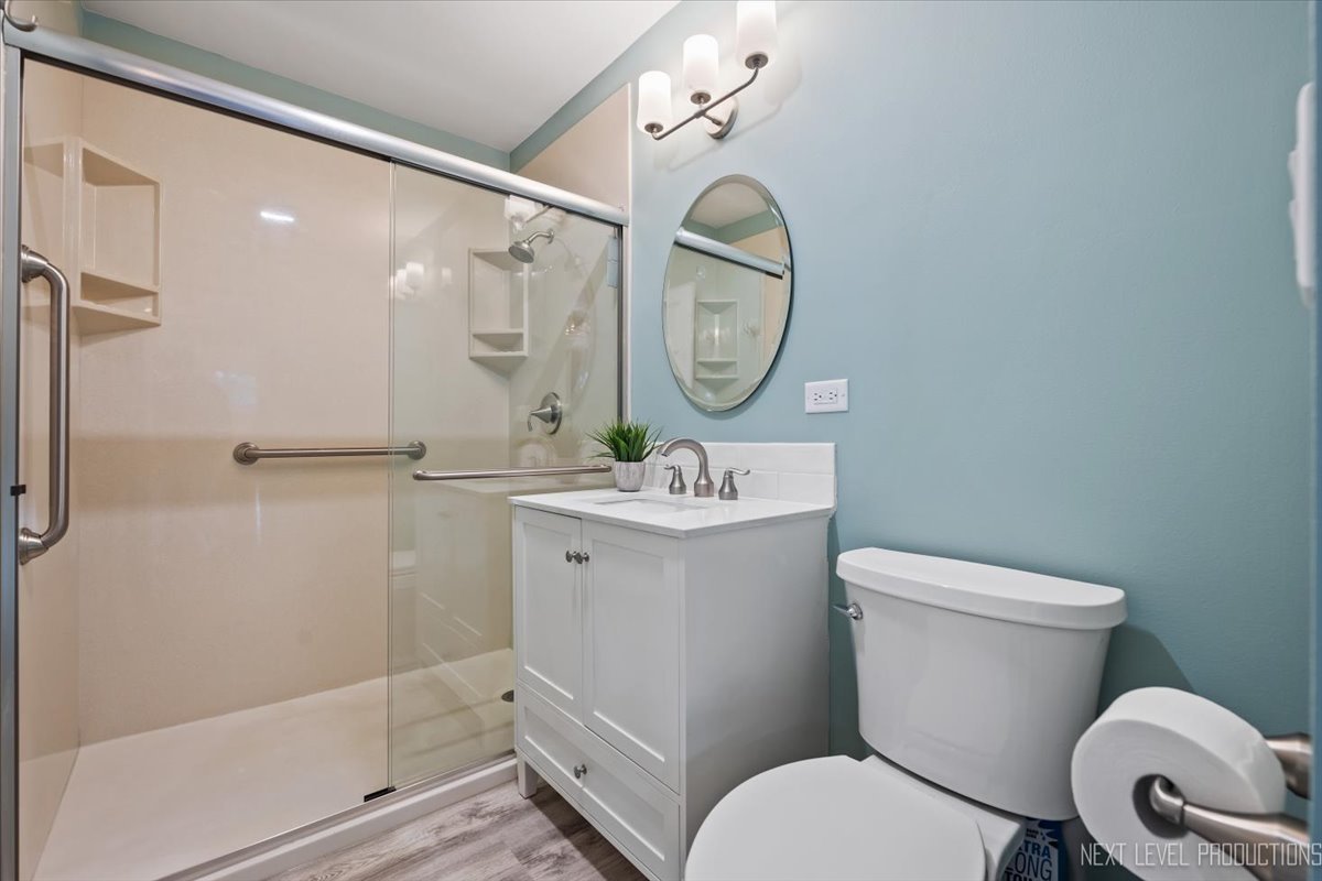 703 Wakeman Avenue Wheaton, IL 60187 - Photo 16 of 20 a bathroom with a sink mirror vanity and toilet