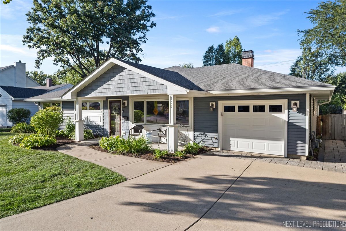 703 Wakeman Avenue Wheaton, IL 60187 - Photo 2 of 20 a front view of a house with a garden and plants