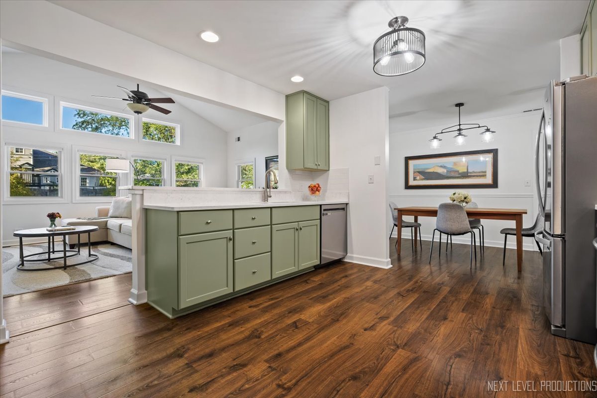 703 Wakeman Avenue Wheaton, IL 60187 - Photo 6 of 20 a room with stainless steel appliances a kitchen island hardwood floor and a view of living room