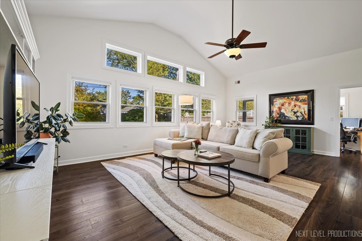 703 Wakeman Avenue Wheaton, IL 60187 - Photo 9 of 20 a living room with furniture a chandelier and a window