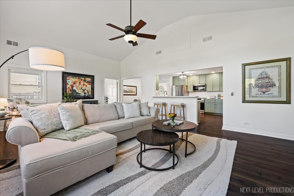 703 Wakeman Avenue Wheaton, IL 60187 - Photo 10 of 20 a living room with furniture kitchen view and a wooden floor