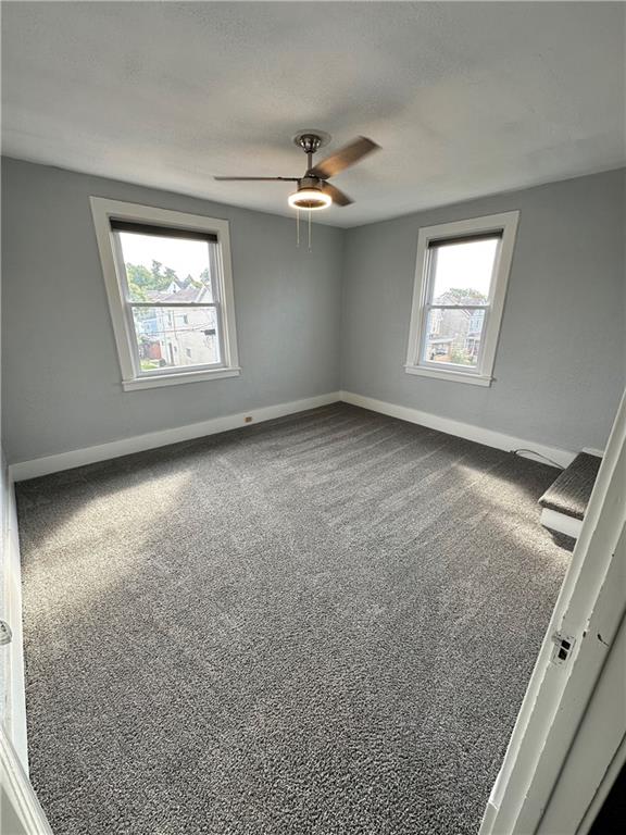 120 Rinne Street Pittsburgh, PA 15210 - Photo 4 of 29 an empty room with windows and ceiling fan