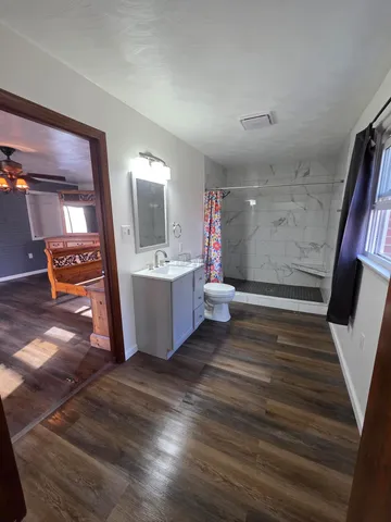 a view of a room with wooden floor and stairs
