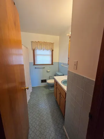 a bathroom with sink mirror vanity and toilet