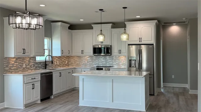 a kitchen with microwave stove and cabinets