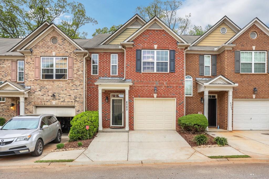4045 Fireoak Drive, Unit 49 Decatur, GA 30032 - Photo 1 of 1 a front view of a house with a yard and garage