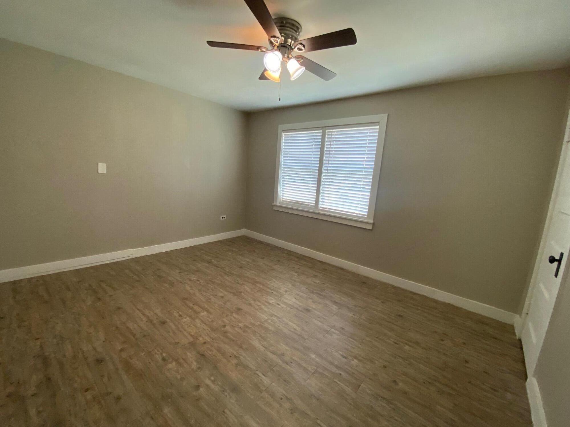 207 East 5th Street Sundown, TX 79372 - Photo 11 of 13 an empty room with a window and a fan